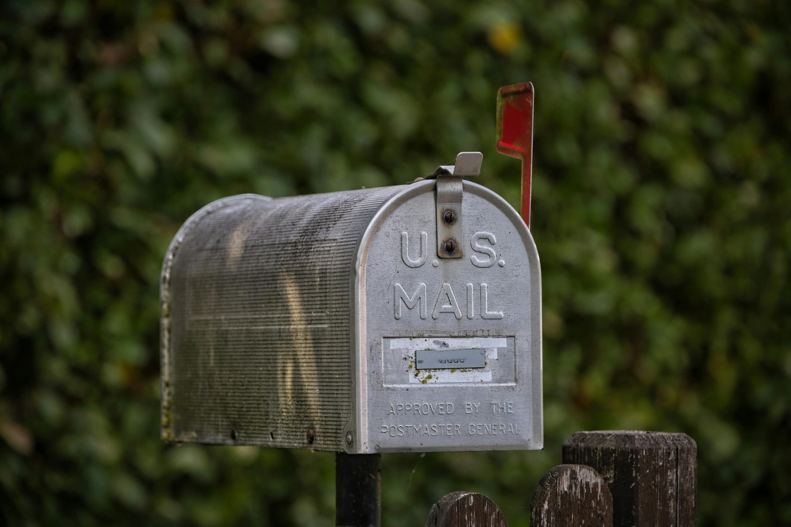 USPS mailbox – direct mail hero An old aluminum mailbox with the red flag up, signaling outgoing mail is ready to go.